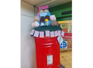 Slough knitting group creates post-box topper to mark Breast Cancer Awareness Month