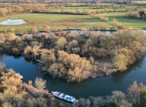 Heavily wooded island in Thames sold at auction for almost £100,000