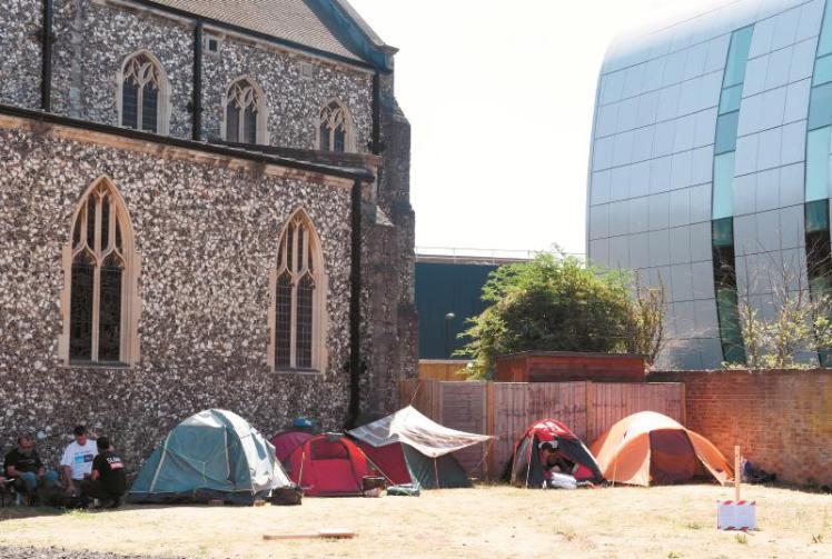Homeless people camping outside church given notice to vacate